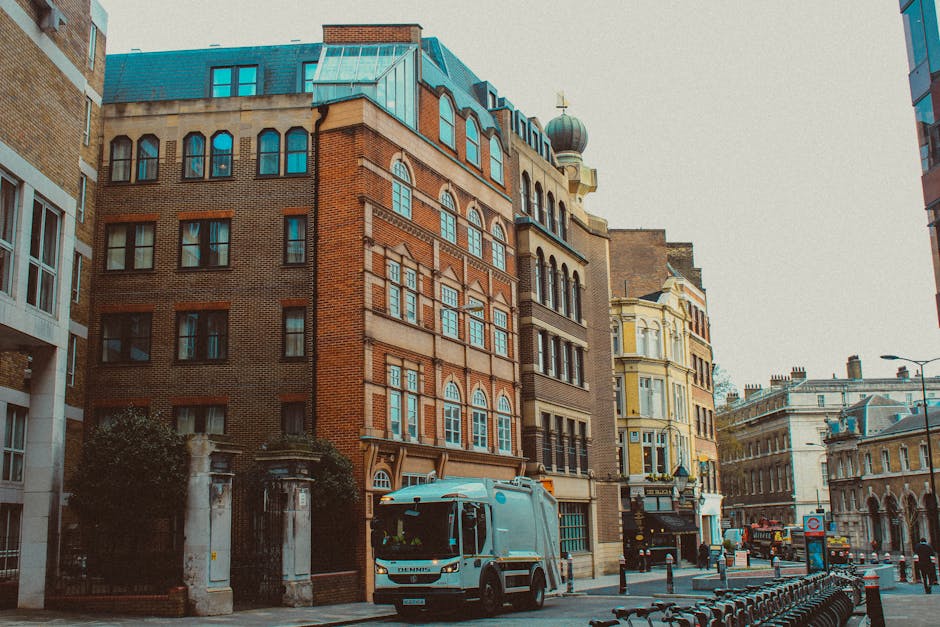 Image of a multi-storey Victorian-style building with a white facade and large bay windows, situated on a busy street. On the ground floor, there is a restaurant with a beige awning labeled 'SUTINE' a